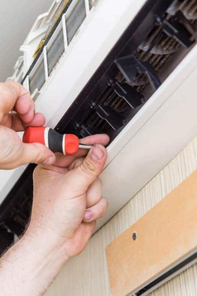 Male Hands While Doing Air Conditioner Repair — Air Conditioning for Home & Business Taylors Beach, NSW